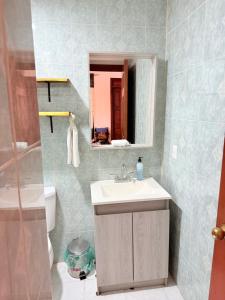 a bathroom with a sink and a mirror at Casa de 3 recámaras en Bacocho in Puerto Escondido