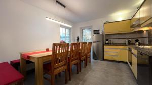 a kitchen with a wooden table and some chairs at Ferienhaus Hörnchen in Hellenthal