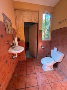 a bathroom with a toilet and a sink at Casa Nawara in Puerto Escondido