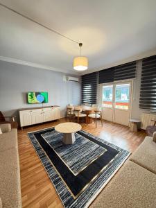 a living room with a table and a dining room at New Hotel Harbiye in Istanbul