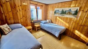 En eller flere senge i et værelse på 360 Viewpoint Alpine Apartments "Mont Blanc"