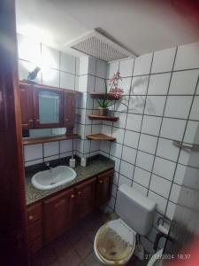 a bathroom with a toilet and a sink at Triplex na Prainha in Arraial do Cabo +16 photos