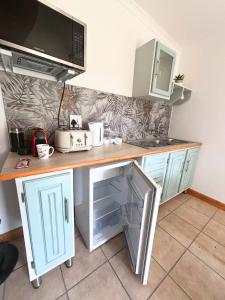 a kitchen with a counter top with a refrigerator at Cottage of Grace in Benoni