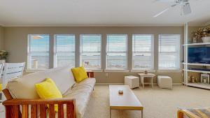 a living room with a couch and some windows at Sun and Moon in Port Bolivar +31 photos