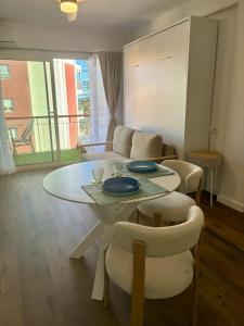 a living room with a white table and chairs at Nook arenal Jávea in Platja de l'Arenal