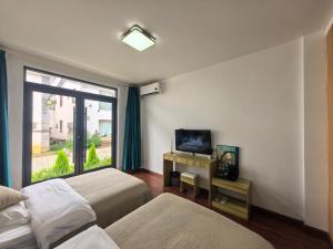 丽江馨舍精品客栈的有两张床和一扇窗户的酒店房间