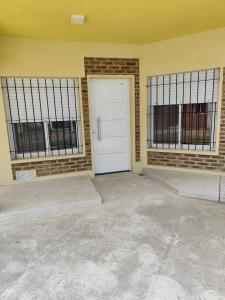 eine Garage mit einer weißen Tür und zwei Fenstern in der Unterkunft Los cuatro soles in San José