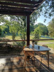 a table and two chairs on a porch with a view at Lodge Slow Life - Mas de Rey in Arpaillargues-et-Aureillac