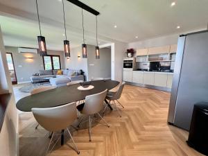 a dining room and living room with a table and chairs at The Penthouse Sarajevo in Sarajevo