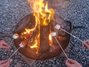 a grill with a bunch of fire on it at I do glamping penhallow campsite Ltd in Truro