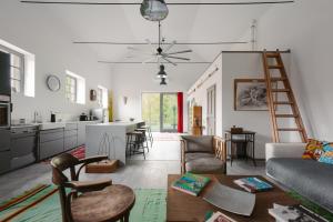 a kitchen and living room with a couch and a table at LOFT Köveskál in Köveskál