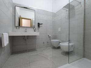 a bathroom with a toilet and a sink and a mirror at Oasis Hotel Residence Resort in Lampedusa +34 photos