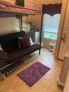 a living room with a couch and a bunk bed at Rainbow Springs Private 4 acre Country Retreat in Ocala