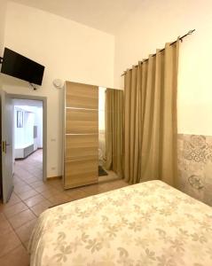 a bedroom with a bed and a television in it at Morgera N8 in Forio d'Ischia