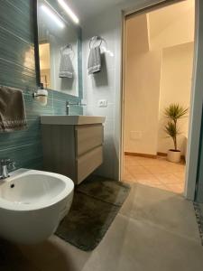 a bathroom with a white sink and a mirror at Morgera N8 in Forio d'Ischia