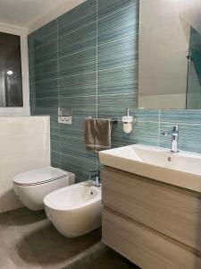 a bathroom with a white toilet and a sink and a tub at Morgera N8 in Forio d'Ischia +10 photos