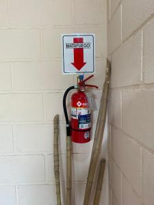 a fire hydrant is hanging on a wall with skis at Aiken Embalse in Embalse