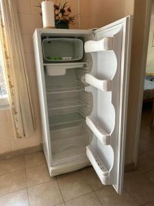 an empty refrigerator with its door open in a kitchen at Aiken Embalse in Embalse