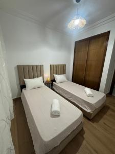Postel nebo postele na pokoji v ubytování Tanger Prestige Residence + 2 fotografie