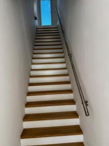 a staircase with white walls and wooden steps at Zum Herold in Thale