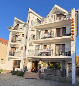 a large white building with balconies on it at Casa Anamaria in Baile Felix