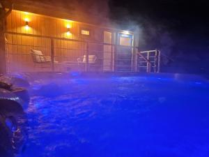 a house with a swimming pool at night at Villa Rustica in Bešeňová