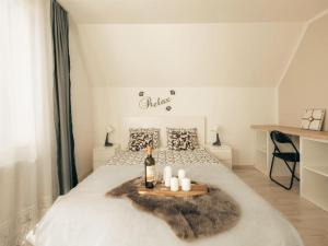 a bedroom with a bed with a bottle of wine and candles at Apartment Mountain Sunrise in Škofja Loka