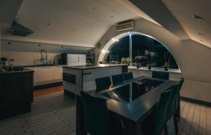 a kitchen with a table and chairs in a kitchen at Apartment Mountain Sunrise in Škofja Loka