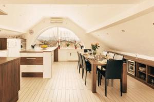 a kitchen and dining room with a table and chairs at Apartment Mountain Sunrise in Škofja Loka