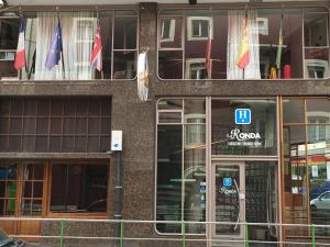 a building with flags in front of it at Hotel La Ronda in Castro-Urdiales