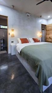 a bedroom with a large bed and two lamps at Lagalag Studios in El Nido