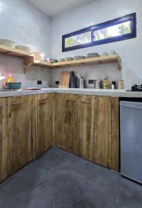 a kitchen with wooden cabinets and a window at Lagalag Studios in El Nido +17 photos