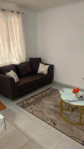 a living room with a couch and a table at Namfrey Sunny in Kiserian