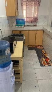 a kitchen with a stove and a table in it at Namfrey Sunny in Kiserian