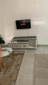 a room with a keyboard and a tv on a wall at Namfrey Sunny in Kiserian