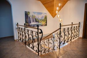 a staircase in a house with a painting on the wall at Kwatery prywatne u Danusi in Wierchomla Wielka