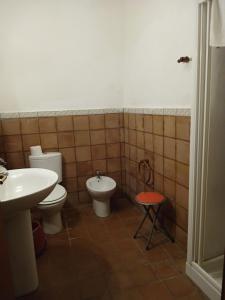 a bathroom with a toilet and a bidet and a sink at Case Zuccaro in Trecastagni +64 photos