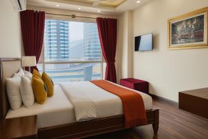 a hotel room with a bed with a large window at Bella Hotel Apartments- Executive Stay Opposite Centaurus Mall Islamabad in Islamabad +152 photos