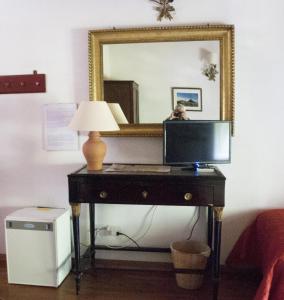 a desk with a computer on it with a mirror at Case Zuccaro in Trecastagni