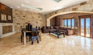 a living room with a couch and a table at SeaStone Villa in Hersonissos