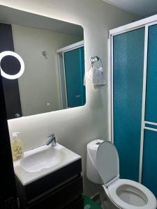 布卡拉曼加Apartamento acogedor en Bucaramanga con piscina的浴室里有洗手池、马桶和镜子。