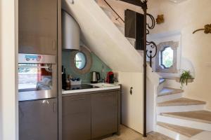 a kitchen with a sink and a staircase in a house at Medieval Tower In Sibillini Mountains Park in Vetice