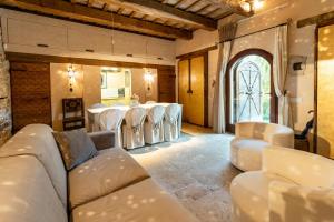 a large room with white chairs and a table at Medieval Tower In Sibillini Mountains Park in Vetice