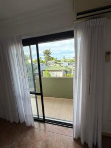 a room with a large window with white curtains at Fenix 2 in Colón