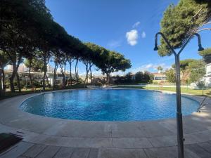 a large swimming pool with trees in a park at Studio La Calita in Mijas Costa