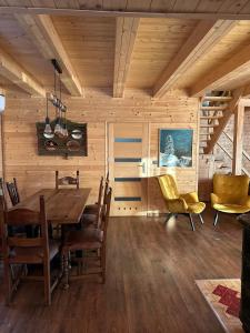 a dining room with a wooden table and chairs at Dom drewniany z sauną i jacuzzi w Szklarskiej Porębie in Szklarska Poręba