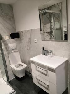 a bathroom with a white sink and a toilet at Pension bei Laura in Schwerte +6 photos