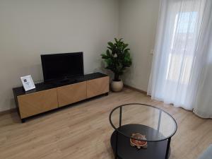 a living room with a flat screen tv on a cabinet at SANTA EULALIA muy céntrico in Zamora