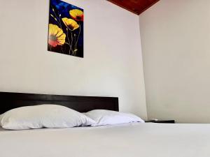 a bedroom with a bed with a painting on the wall at Hotel San Pedro in Monterrey +2 photos