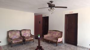 two chairs in a living room with a ceiling fan at Suite 103 Cordoba Centro con Estacionamiento in Córdoba